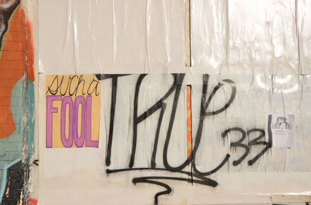 paste up graffiti that says such a fool. Someone has written true in large letters beside it. 