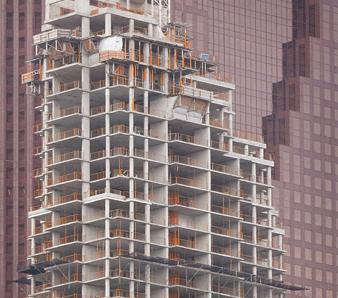 a building under construction in front of another building