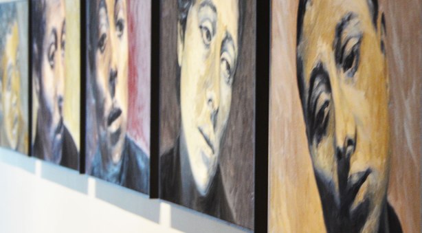 a series of 5 women's faces hung in a row on the art gallery wall, paintings by Will Gorlitz 