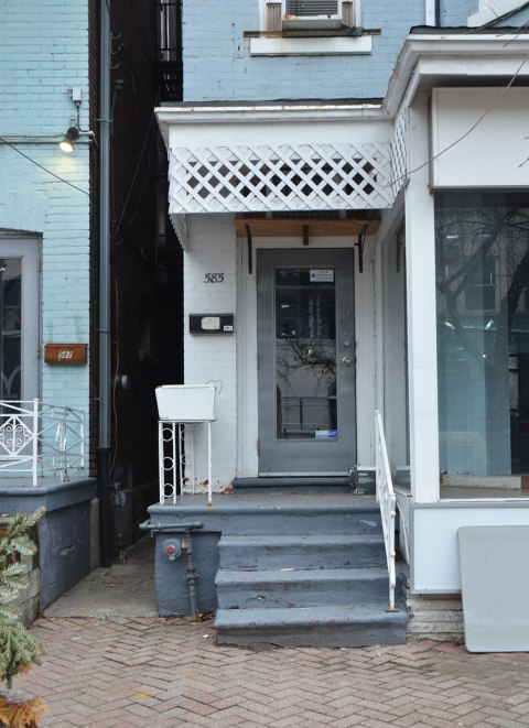 grey door, white porch, crooked grey steps