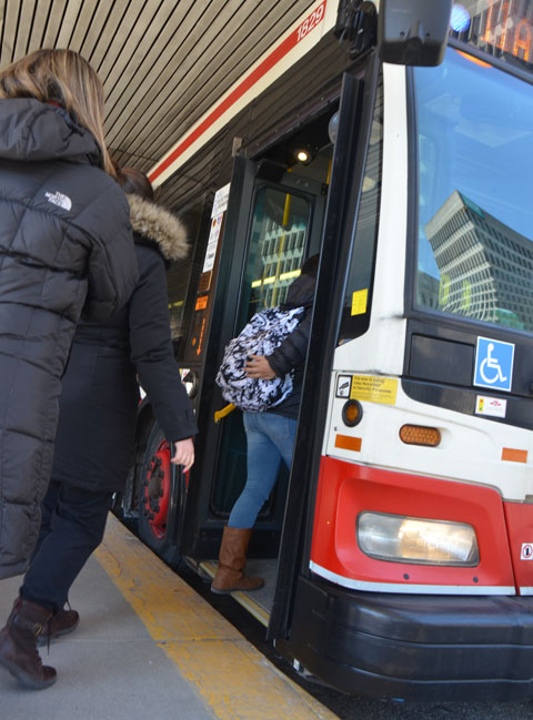 people getting on a TTC bus at Davisville station