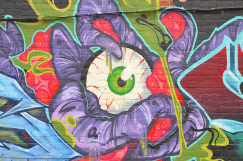 big eyeball painted in the midlle of a mural