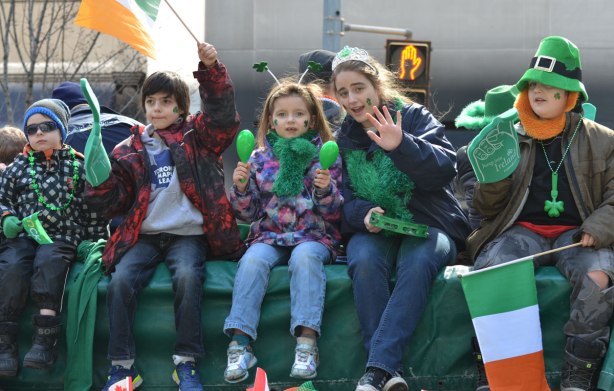 five kids sitting on a float in the St. Patricks day parade