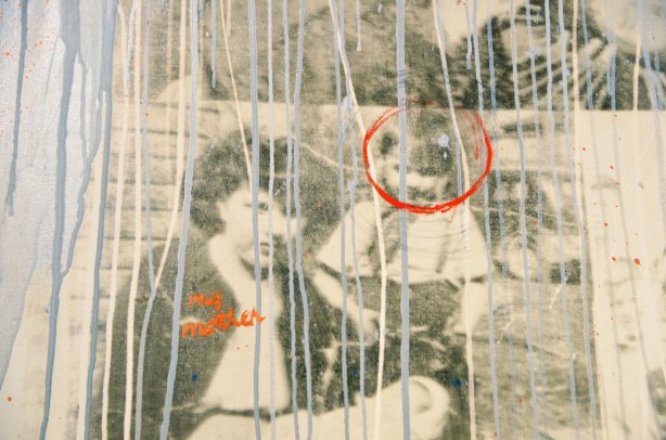part of Time Dissolve, an artwork by Carl Beam. Old photo of a woman seated on the ground bRed letters saying my mother are written on the woman and a red circle is around the boy's head 