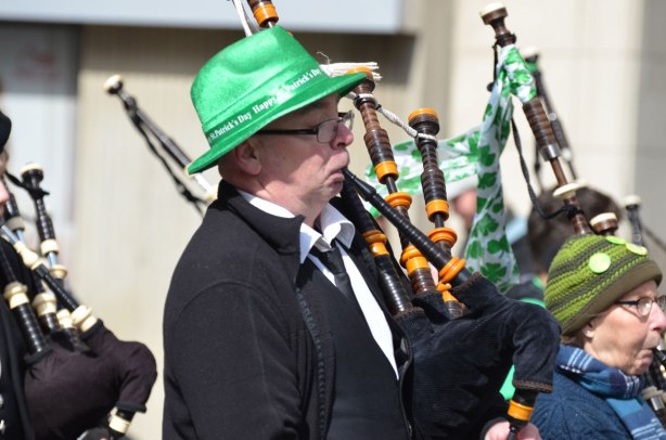 bagpipe player wearing a green hat for St. Patricks day 