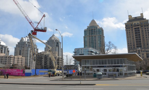 south entrance to Bayview subway station with tall residential buildings behind and a construction site beside 