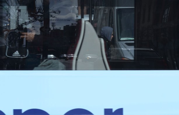 looking into the window of a streetcar, people sitting, 