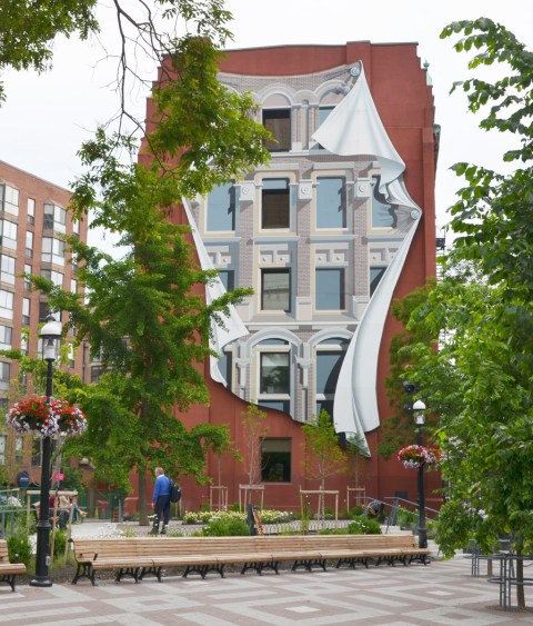 mural of windows and facadde on the back of the flatiron building with the redesigned Berczy park planting and benched in front of it