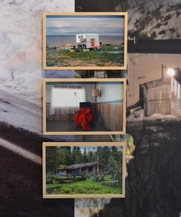 three colour photos in simple light wood frames mounted on a wall that is covered with large images