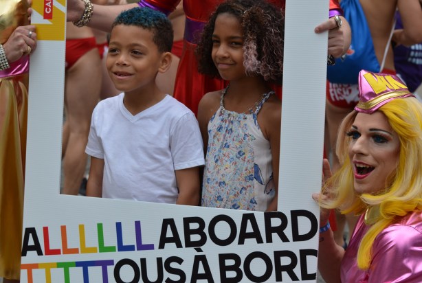 two young kids, a boy and a girl, are standing within a white cut out square (instagram thing) that says alll aboard on the bottom