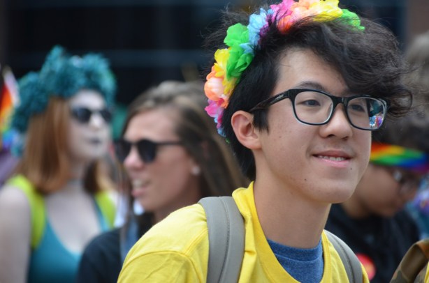 a young man with a flower garland in his hair (paper flowers)