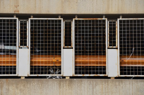 metal grille, part of a barricade along the side of a parking structure, rusted, 