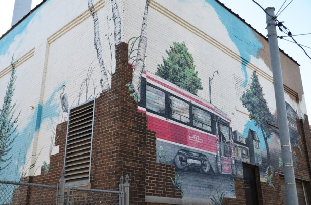 a mural of a ttc streetcar and a heron 