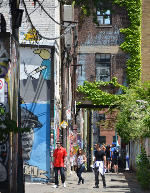 people walking down Graffiti Alley on a sunny afternoon 