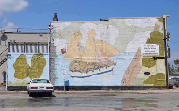 painted mural of a schooner from the 1790s sailing on Lake Ontario