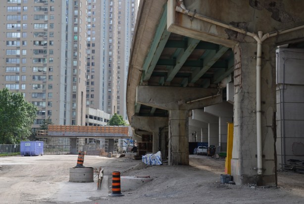 under one of the Gardiner Expressway ramps, with new bents being built for a new ramp in the background. 