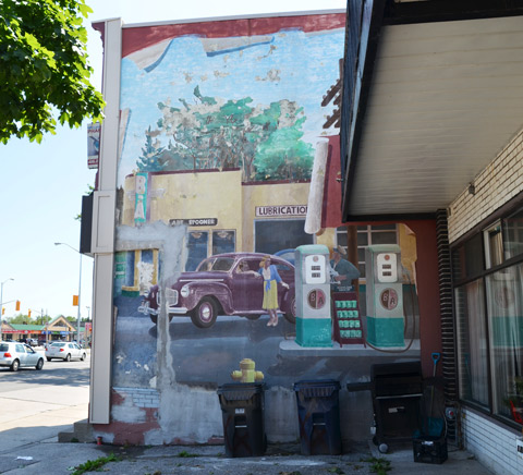 part of a mural showing a gas station from the 1940s or 1950s