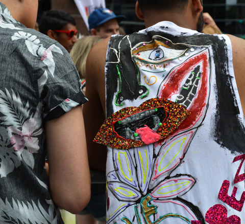 the back of a decorated t-shirt, glitter lips with tongue stuck out. 