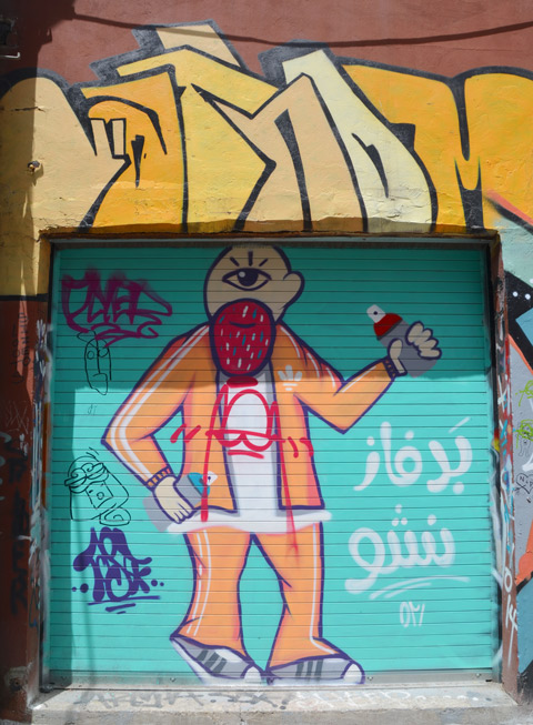 street art painting on a garage door, turquoise background, a man standing with a spray paint can in his hand, awkeardly drawn, simplistic, man with only one eye and a large beard that looks like a strawberry 