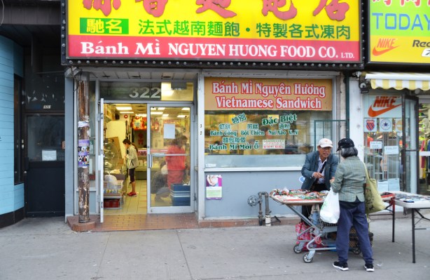 a man sells items outside a Vietnamese restaurant