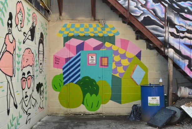 blocks in a mural look like abstract houses and circles for trees, by Jieun June Kim 