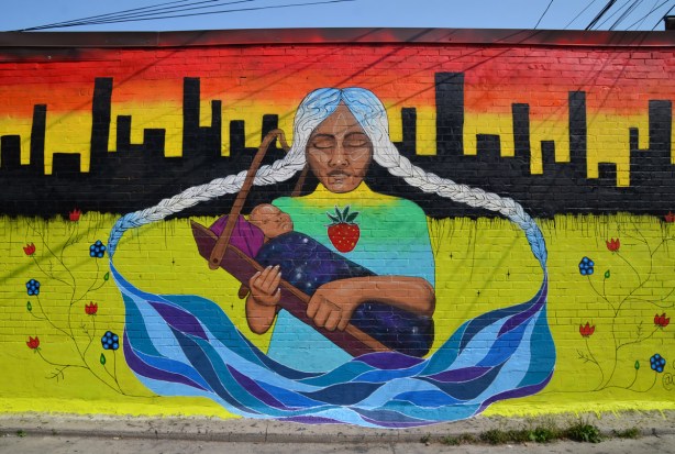 mother sitting holding child (baby) in First Nation like theme, black city skyline in the background, by auralast and chiefladybird , yellow background with flowers