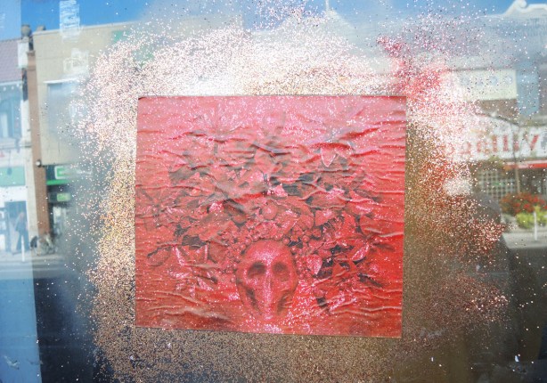 red paper paste up with gold glitter all around it. 