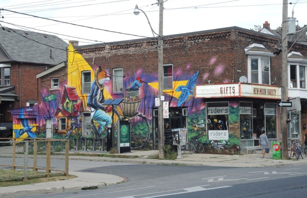 photo of the whole mural by Clandestinos (Shalak Attack and Bruno Smoky) on the side of Riders bike store,