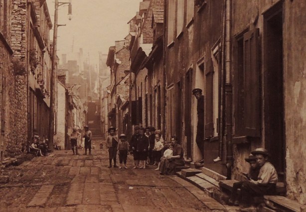 details of a vintage photo, street scene, kids, row houses, 