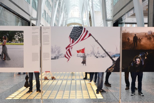 photos at an exhibition at Brookfield Place (Alan Lambert Galleria), of portest of Dakota Access Pipeline, by Canadian photographer Amber Bracken 