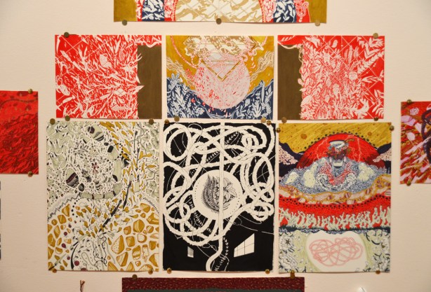 pen and ink, and paint, drawings by sab meynert on a gallery wall, thumb tacked to the wall,