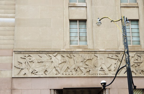 relief sculpture across the top of the door of the old Stock Exchange Building on Bay street, scenes of people working 