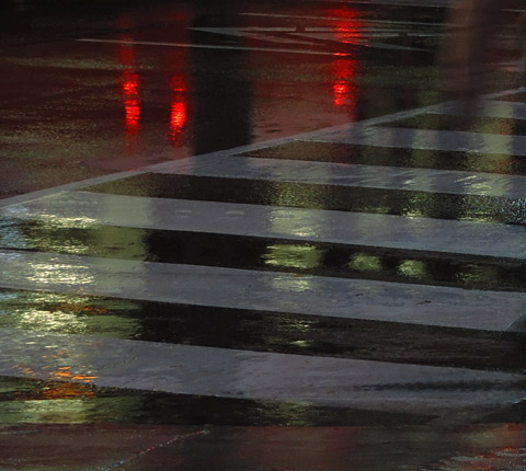 lights reflecting on a wet street, crosswalk