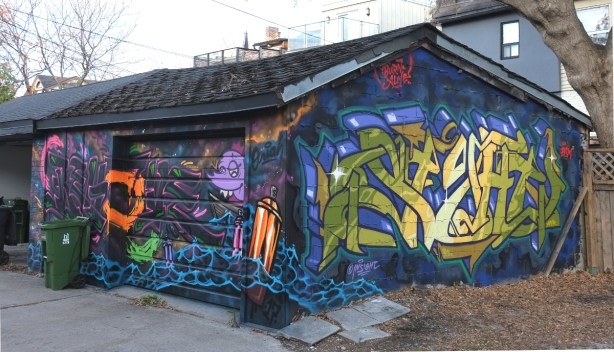 sides and front of garage with street art on them 