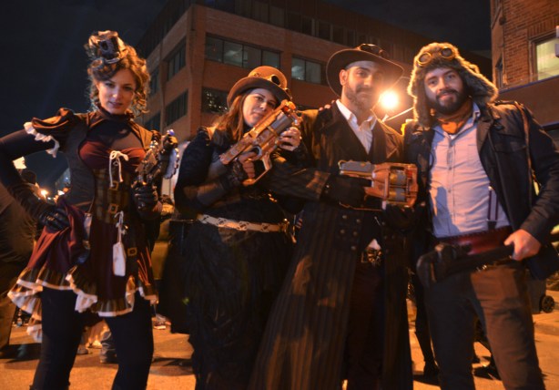 a group dressed up for Halloween, night time, street party, 2 women, 2 men, toy guns, gangsters and burlesque. 