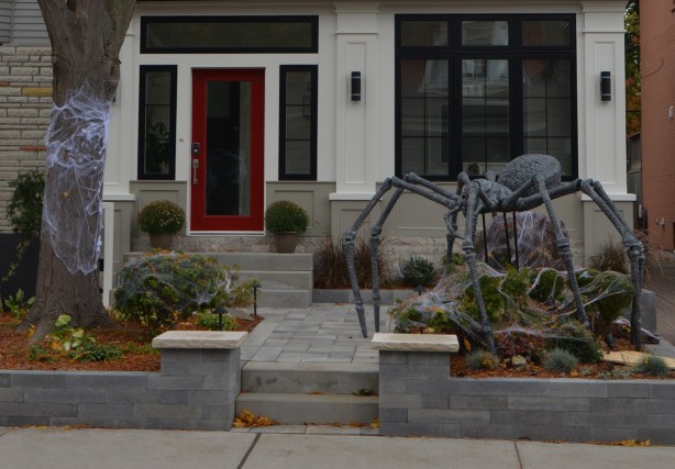 a giant spider halloween decoration in front of a house
