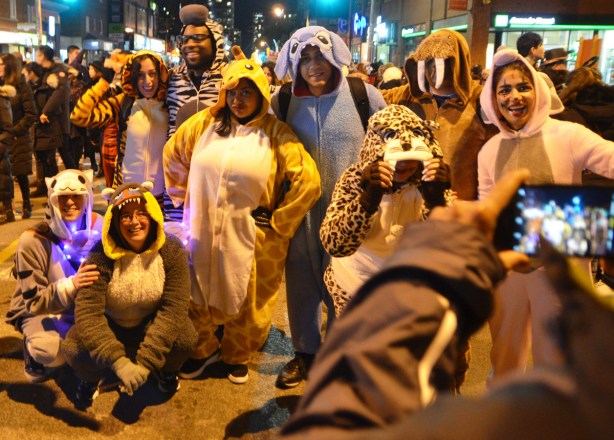 a group in full animal costumes pose for a photo, a walrus, a shark, a cat, a leopard, 