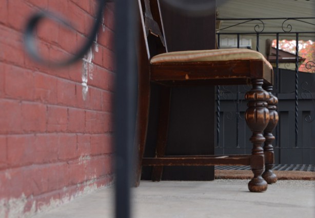 an old chair on a porch, side view. 