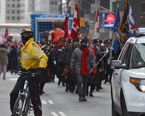 Toronto FC parade, people dressed in red and white, police escort at the front of the parade
