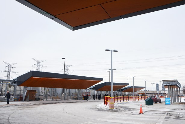 exterior at new Pioneer Village TTC subway station at Steeles Ave., new bus loops with wood overhangs, still under construction