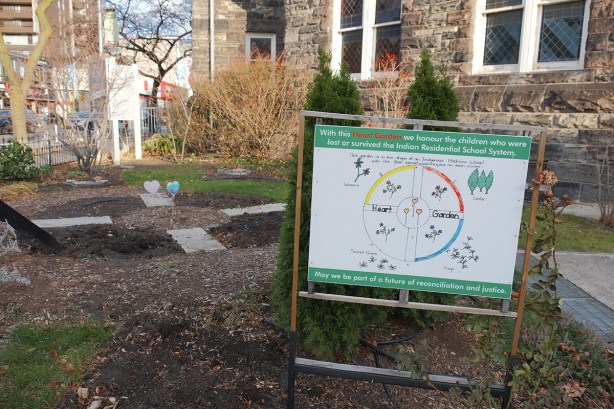 sign in a garden beside a church on a corner, autumn so there isn'tmusch growing in it, recnciliation garden 
