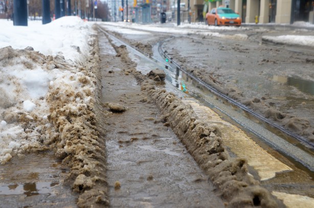 dirty slush along the streetcar tracks on Queens Quay