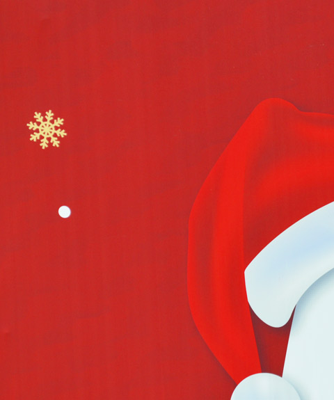part of sign, red background, a gold snowflake and part of a red and white Santa hat 