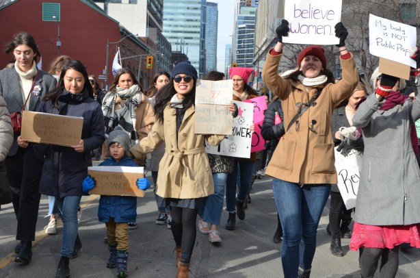 women walking down Bay st towards Nathan Phillips square and city hall, womens march 