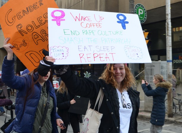 women holding protest sign, womens march, Toronto