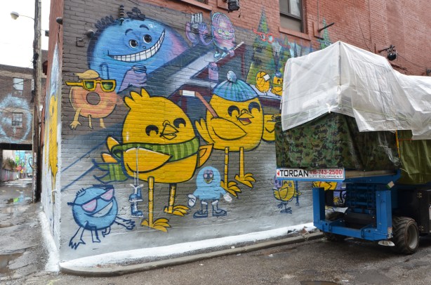 uber5000 mural in the process of being painted in graffiti alley