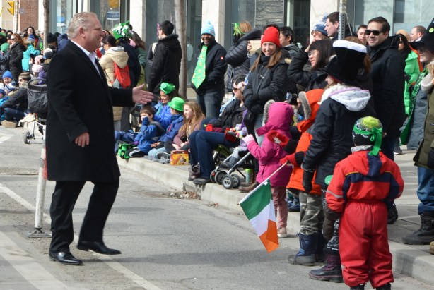 Doug Ford, St. Patricks day parade, wakls towaards the people on the sidewalk to shake hands, politician, politics, 