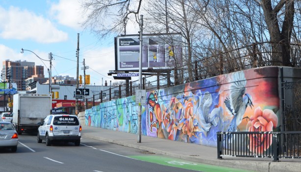 mural on a wall beside a busy street