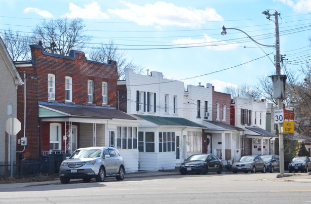 older two storey row houses with facades that extend above the roof line,