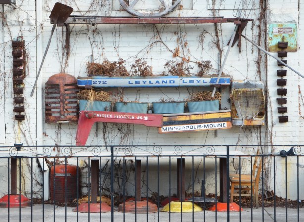planters on an exterior wall, made of truck and tractor parts